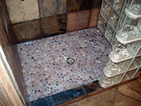 Shower with a Glass Wall, Stone Pan and Slate Tiles